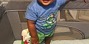 Tyler joined the competition — help win amazing prizes! baby, bed, bedroom, clothing, couch, crib, face, furniture, happy, head, indoors, infantbed, person, photography, portrait, room, shorts, sitting, smile, t_shirt