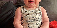 Marvin is registered to the contest to win money with this photo: baby, child, infant, couch, clothing, sleeveless_shirt, pants, red_hair, blue_eyes, smiling, indoor, furniture, curtains, cabinet, blanket, home, person, portrait, sitting, cute