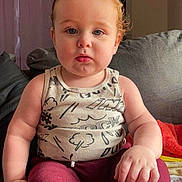 Marvin joined the competition — help win amazing prizes! child, toddler, sitting, indoor, red_hair, tank_top, leggings, couch, pillow, blanket, curtains, cabinet, face, hands, feet, expressionless, home, furniture, person, casual_clothing