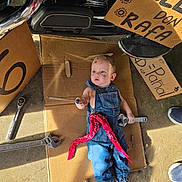 Rafael Mejia is registered to the contest to win money with this photo: baby, child, infant, portrait, lying_down, denim_overalls, bandana, wrench, tools, motorcycle, garage, cardboard, workshop, mechanic, automotive, floor, indoor, wide_eyed, clothing, humor