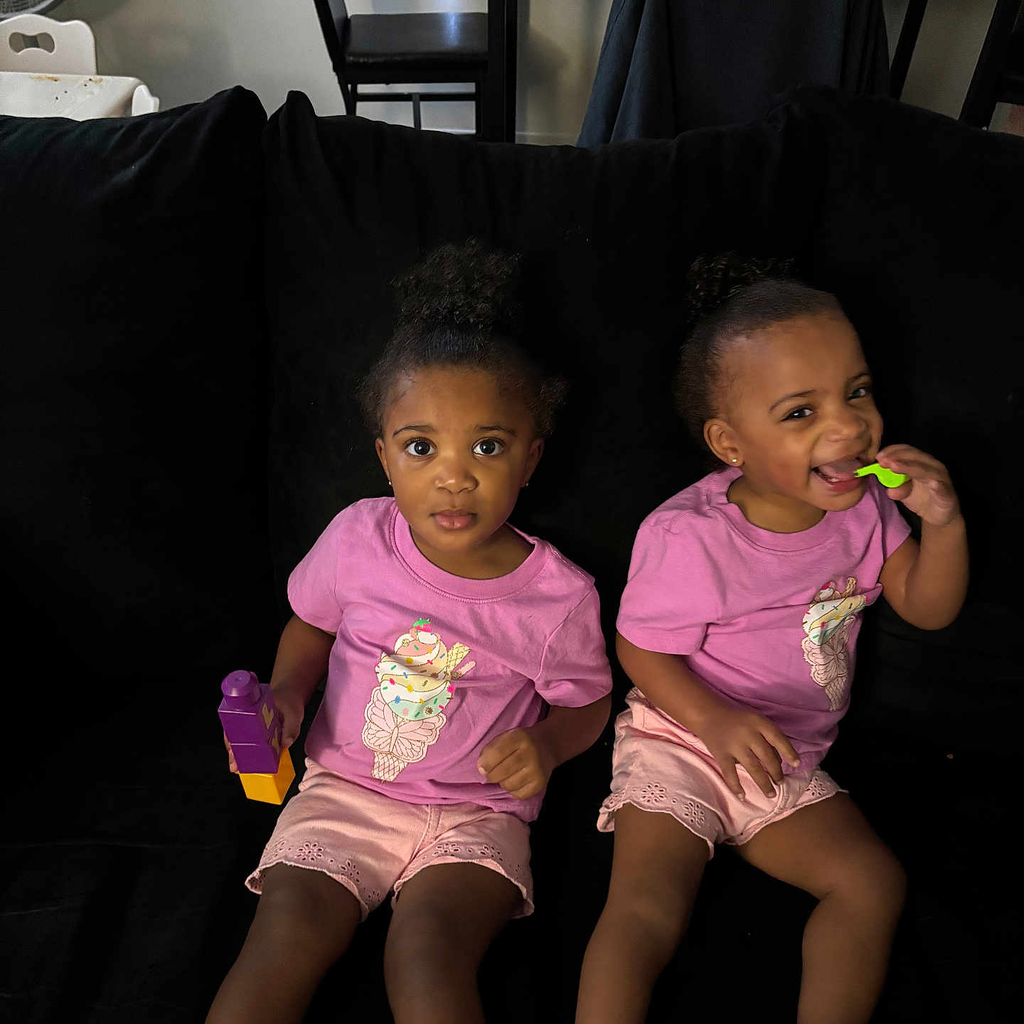 Amiah And Aminah joined the competition — help win amazing prizes! black_couch, blocks, child, couch, curly_hair, cute, footwear, girl, happy, home, indoor, person, pink_shirt, playing, sandals, shorts, sitting, smiling, toddler, toy