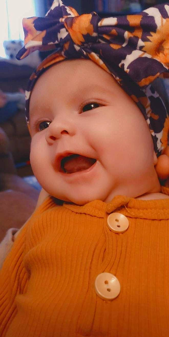 Aurora joined the competition — help win amazing prizes! baby, cheek, chin, eye, finger, gesture, happy, hat, headwear, human_body, iris, lip, mouth, nose, orange, person, pink, red, skin, smile