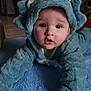 Arès a rejoint le concours — aidez-le/la à gagner de superbes lots ! baby, child, dinosaur_onesie, blue_blanket, indoor, cute, infant, costume, soft_texture, portrait, face, hand, curious, crawling, warm_clothing, toddler, expression, cozy, home, floor