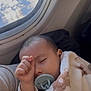baby, pacifier, blanket, sleeping, airplane_window, child, infant, hand, face, cozy, travel, clouds, window, cute, comfort, soft, resting, young_child, clothing, indoors