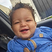 Isaïa a rejoint le concours — aidez-le/la à gagner de superbes lots ! toddler, child, smiling, curly_hair, blue_jacket, teeth, face, portrait, happy, car_interior, seat, clothing, person, young_child, cute, baby, cheerful, closeup, indoor, casual
