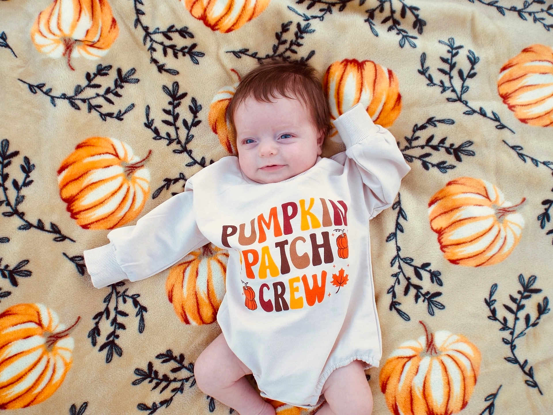 Oakley joined the competition — help win amazing prizes! baby, infant, blanket, pumpkin, onesie, clothing, cute, smile, laying_down, autumn, seasonal, child, face, head, happy, soft_texture, pattern, orange, cream, cozy