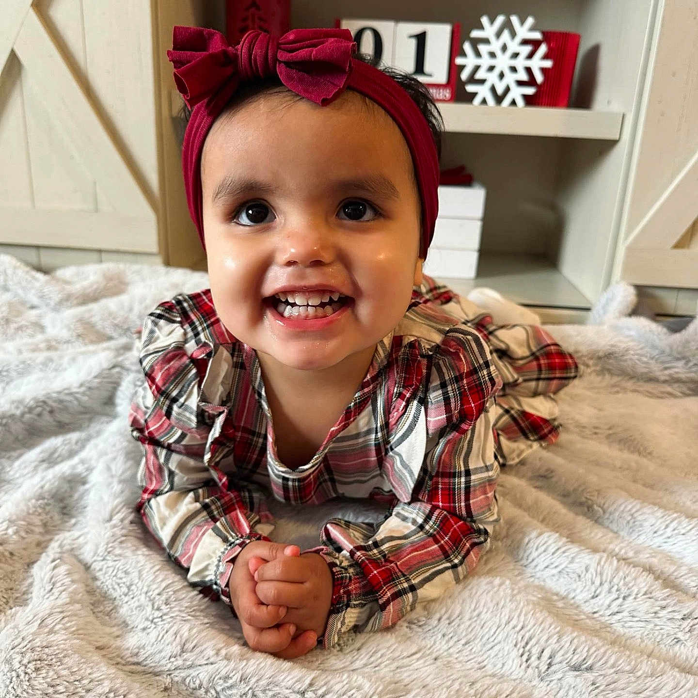 Celeena is registered to the contest to win money with this photo: accessories, baby, babylaughing, bed, bodypart, clothing, face, furniture, handcuffs, happy, head, indoors, mouth, person, photography, portrait, quilt, sitting, smile, teeth