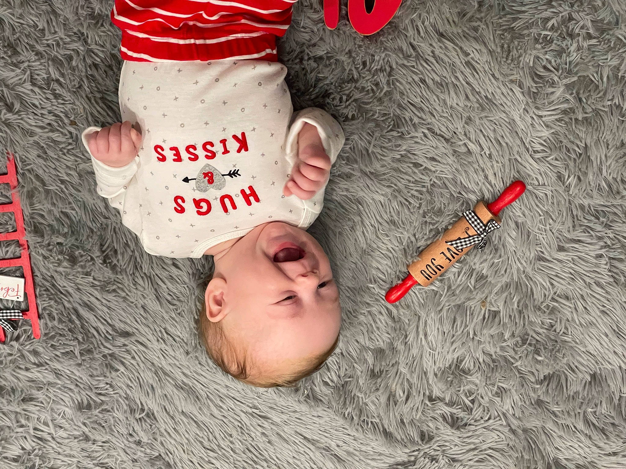 Kane is registered to the contest to win money with this photo: baseball_cap, cap, carmine, child, facial_expression, finger, font, grass, happy, hat, head, headgear, mammal, pattern, person, photo_caption, textile, toddler, tree, vertebrate