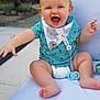 baby, smiling, laughing, child, outdoor, seat, cushion, bib, diaper, pacifier, happy, cute, person, infant, blue_clothing, summer, sunlight, barefoot, playful, garden