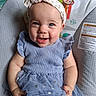 baby, baby_seat, blue_eyes, child, clothing, cute, dress, face, happy, headband, indoor, infant, monkey, pattern, person, portrait, sitting, smiling, sun, tulle_skirt