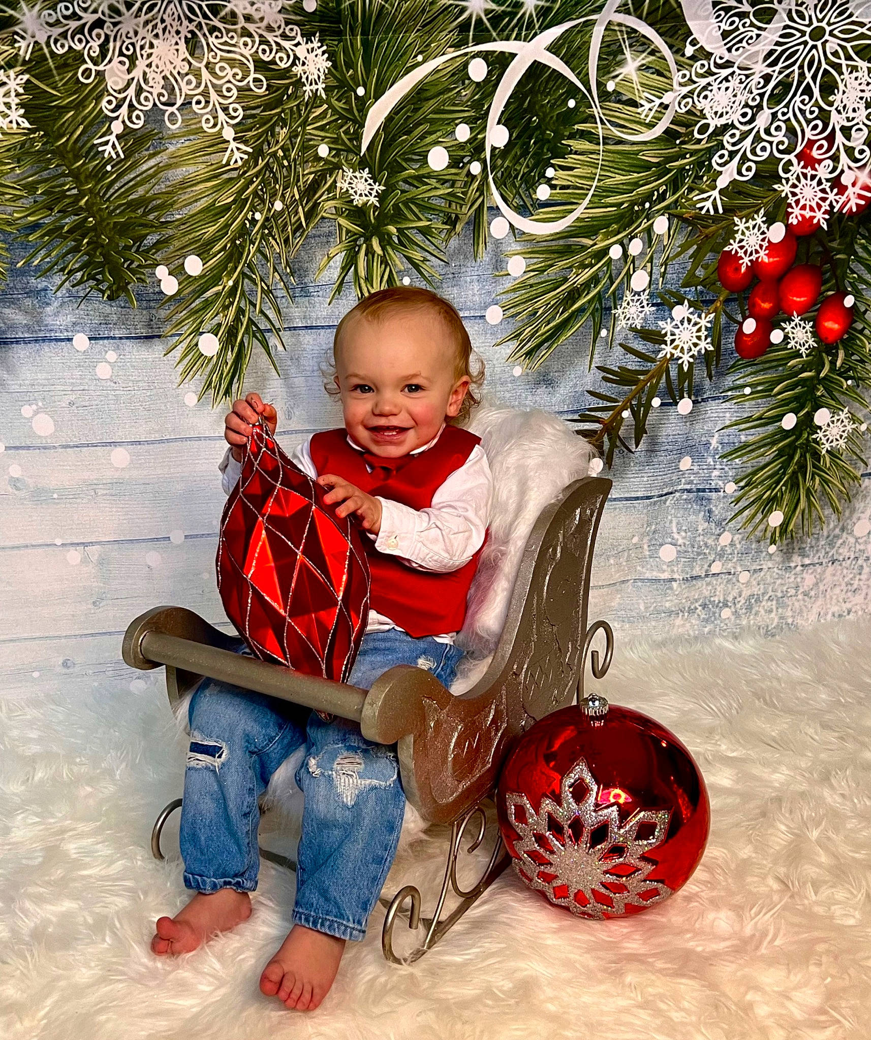 Hayes is registered to the contest to win money with this photo: baby_toddler_clothing, carmine, child, christmas_decoration, christmas_ornament, event, fun, happy, holiday, holiday_ornament, joy, ornament, people_in_nature, person, red, shoe, sitting, smile, toddler, tree