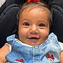 baby, child, smiling, denim, clothing, red_bow, hair_tie, face, eyes, cute, infant, portrait, happy, sitting, close_up, person, apparel, young_child, casual, indoor