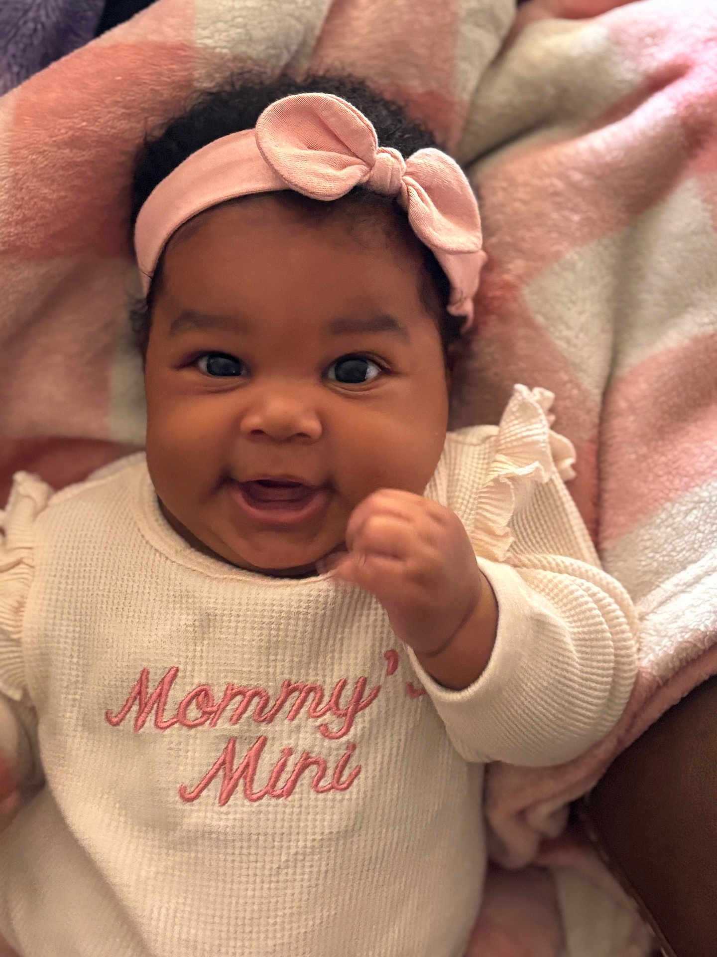 Mikiya joined the competition — help win amazing prizes! baby, infant, smiling, headband, pink, sweater, text, blanket, cozy, cute, child, portrait, happy, indoors, closeup, person, soft, warm_colors, clothing, newborn