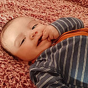 Terrence is registered to the contest to win money with this photo: baby, bed, blanket, bodypart, clothing, face, finger, hand, happy, head, homedecor, mouth, newborn, pants, person, photography, portrait, quilt, smile, towel