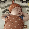 Terrence is registered to the contest to win money with this photo: accessories, americanfootball, americanfootballball, baby, ball, cap, clothing, cushion, face, football, hat, head, homedecor, newborn, person, photography, portrait, sleeping, sport, tape