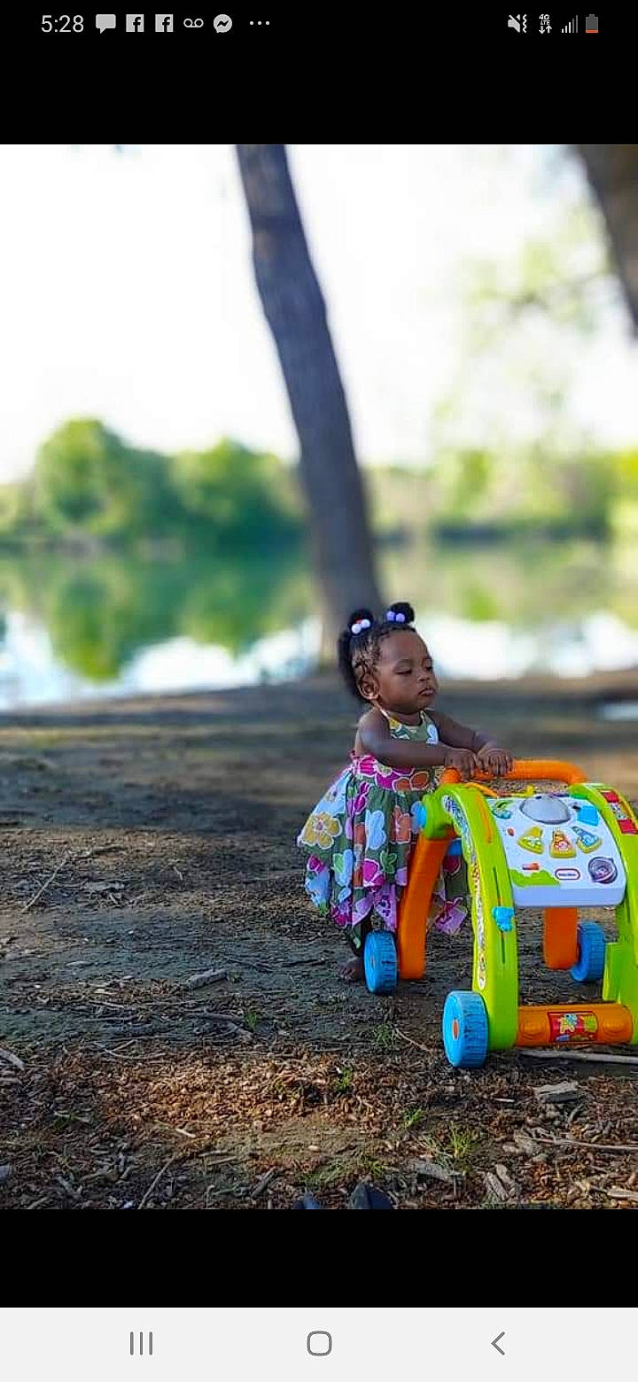 Miss A'Dah is registered to the contest to win money with this photo: child, grass, happy, person, photography, play, sitting, toddler, toy, tree, vehicle