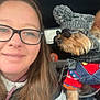 woman, glasses, dog, knitted_hat, pom_poms, sunglasses, sweater, denim_overalls, pet, car_interior, smile, long_hair, casual_clothing, fashion, cute, portrait, cozy, winter_wear, companion, selfie