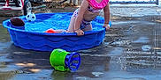 Sophia is registered to the contest to win money with this photo: backyard, blue, child, concrete, curly_hair, fence, happy, outdoor, pink, play, pool, soccer_ball, summer, sunlight, swimsuit, toddler, toy, tricycle, vehicle, water