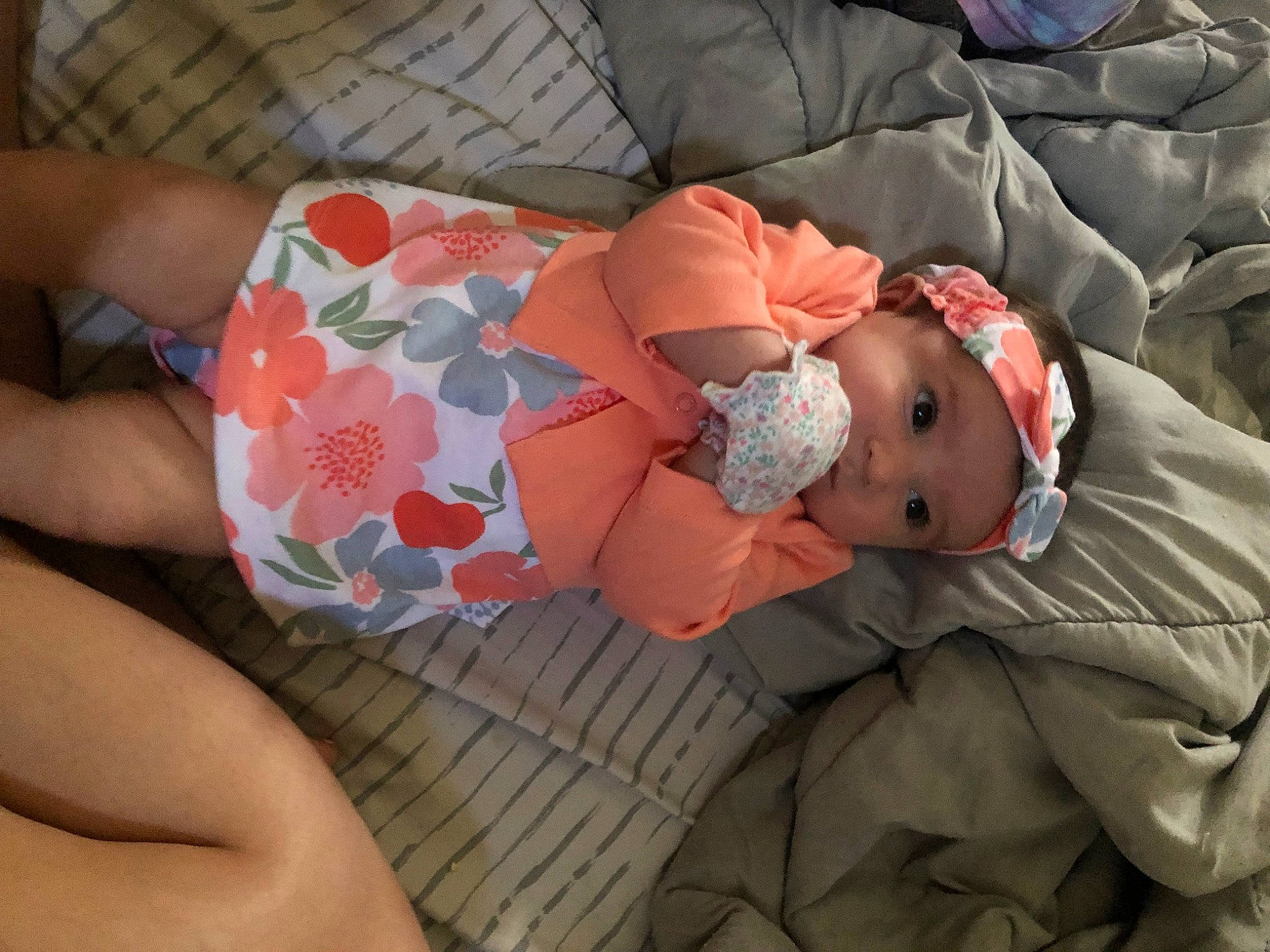Everly is registered to the contest to win money with this photo: baby, baby_products, baby_toddler_clothing, child, comfort, fashion_accessory, headgear, headwear, human_body, human_leg, lap, linens, nail, nap, pattern, person, pink, sitting, skin, sleeve