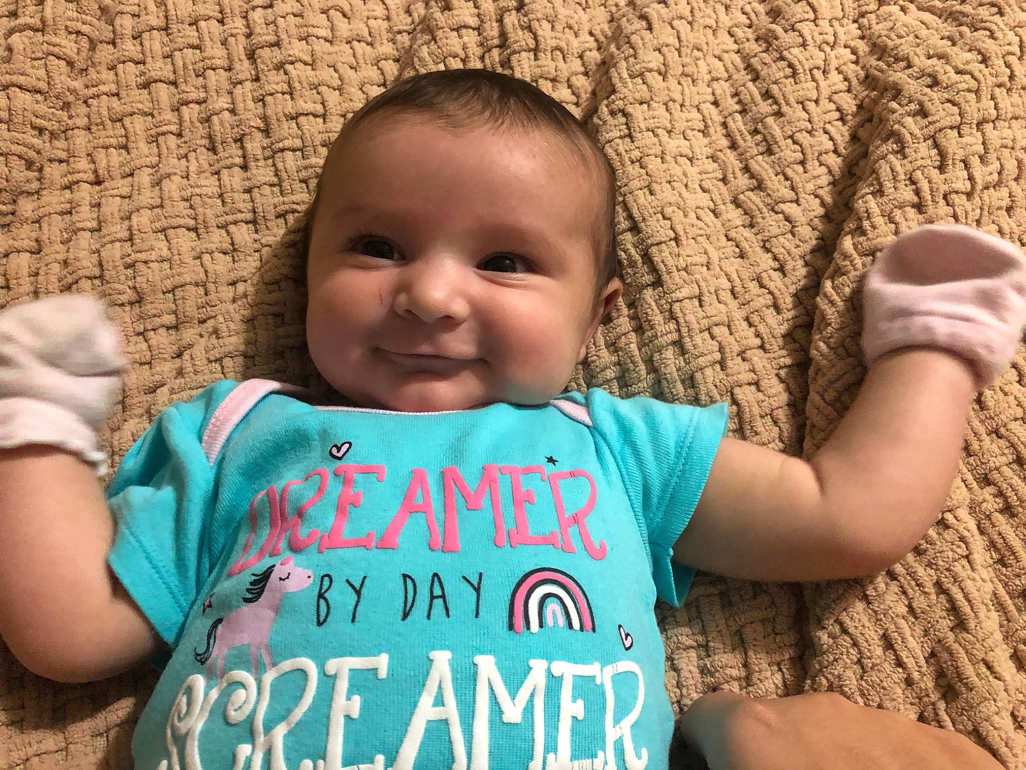 Everly is registered to the contest to win money with this photo: arm, baby_toddler_clothing, cheek, chin, eye, face, finger, gesture, hand, happy, head, human_body, joy, nose, organ, people_in_nature, person, skin, sleeve, smile