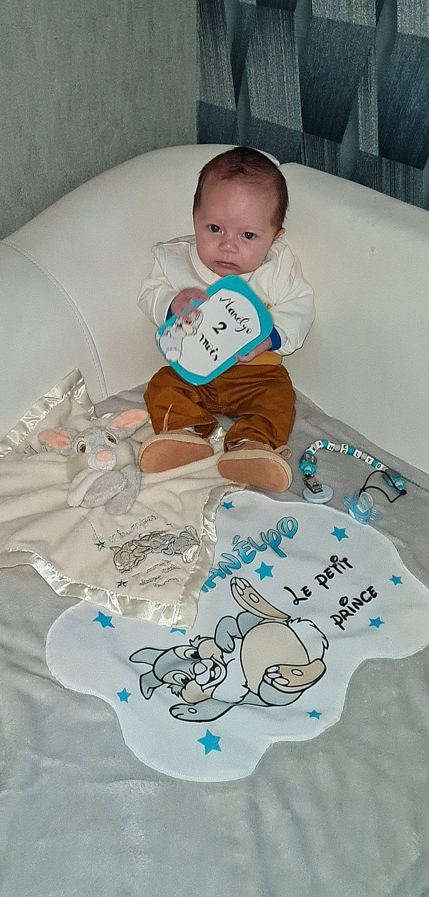 Manélyo participe au concours pour gagner de l'argent avec cette photo : art, baby, baby_products, baby_toddler_clothing, child, comfort, font, head, linens, mammal, pattern, person, room, sitting, sleeve, soccer_ball, t_shirt, textile, toddler, toy