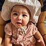 Eden is registered to the contest to win money with this photo: baby, child, hat, pink_outfit, person, portrait, cute, infant, face, eyes, skin, hand, sitting, apparel, headwear, indoor, young_child, smiling, closeup, human
