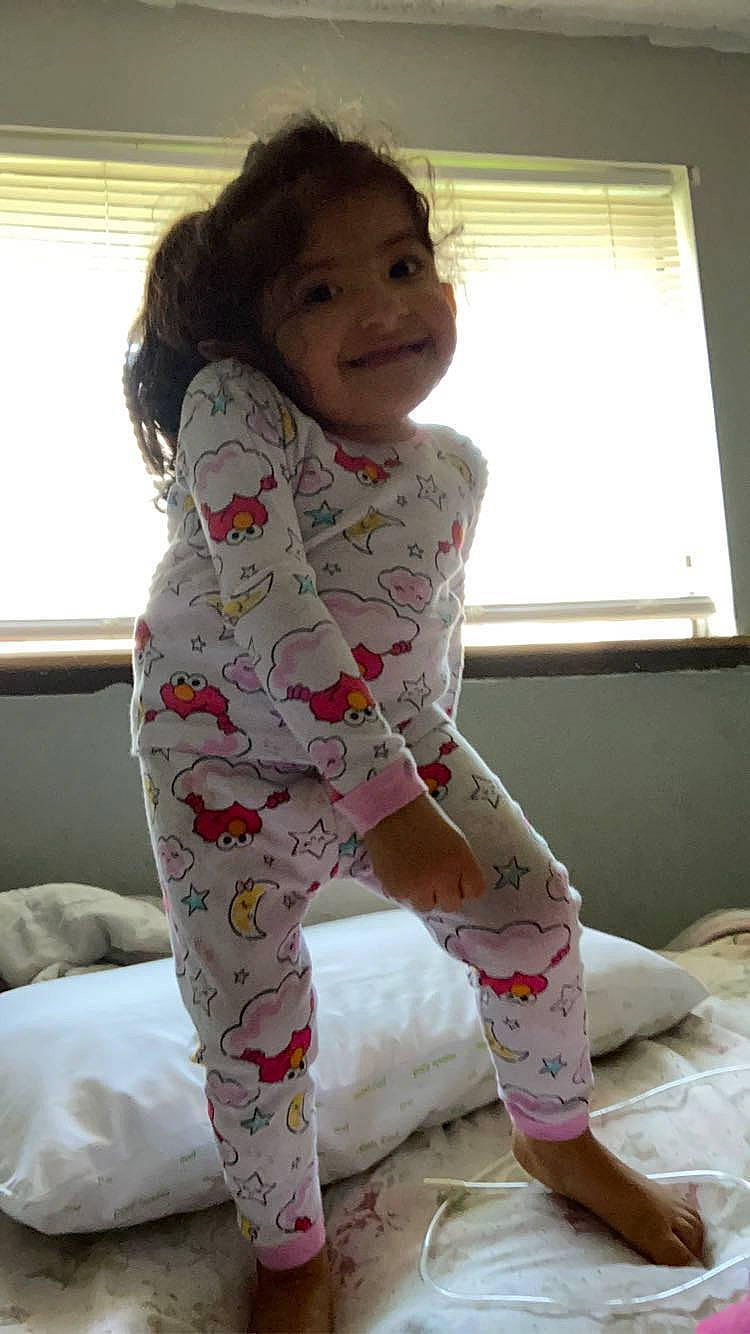 Nancy is registered to the contest to win money with this photo: arm, baby_toddler_clothing, comfort, face, finger, floor, hair, human_body, joint, joy, knee, neck, person, shoulder, skin, sleeve, smile, thigh, toddler, waist