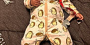 Xavier is registered to the contest to win money with this photo: baby, smiling, onesie, hedgehog_pattern, pacifier, blanket, brown_blanket, white_socks, headwear, infant, cute, happy, lying_down, indoors, soft_lighting, cozy, child, small_hands, cute_outfit, sleepwear