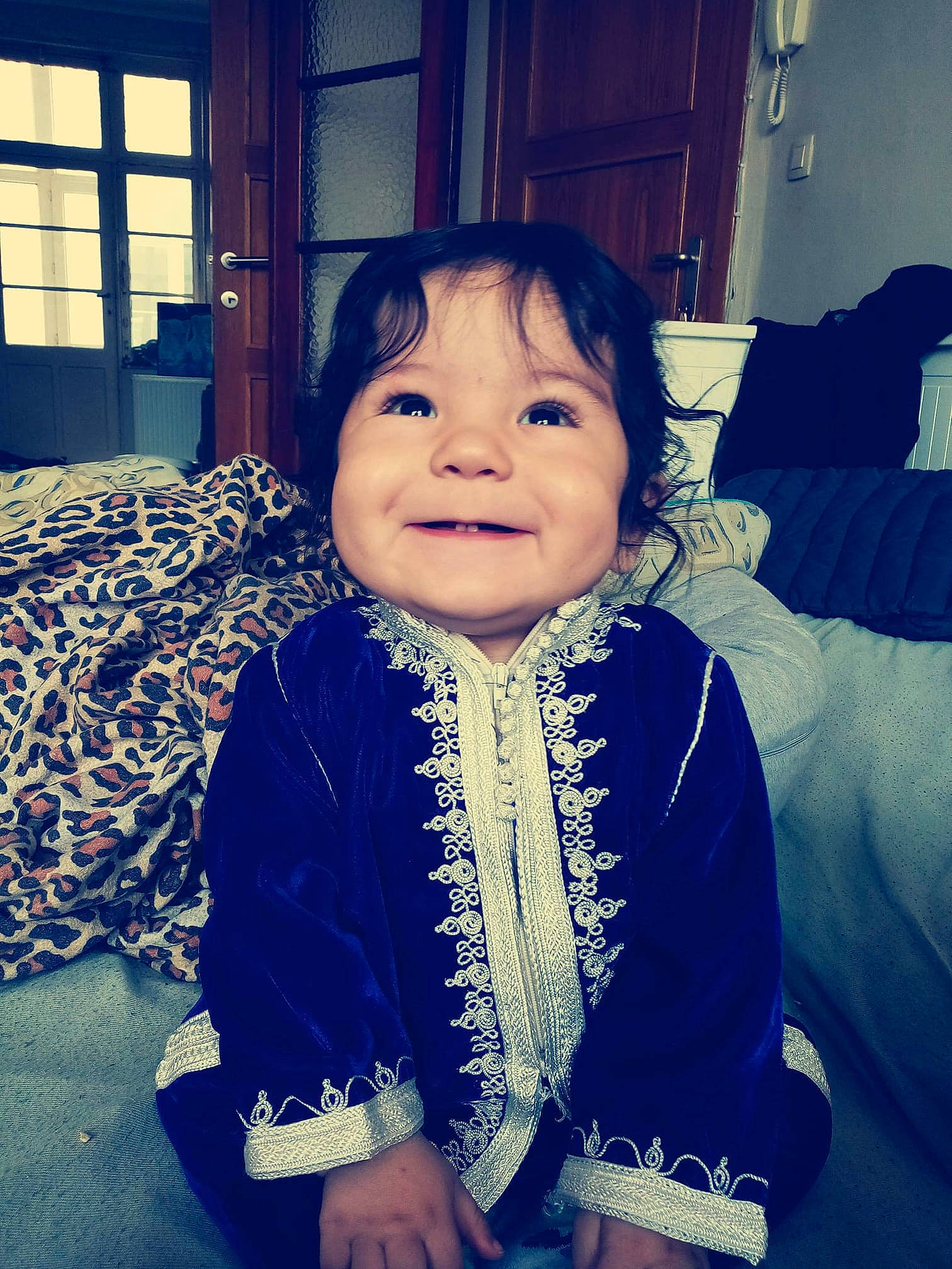 Shahine participe au concours pour gagner de l'argent avec cette photo : cheek, child, cool, eye, face, happy, head, iris, jacket, joy, outerwear, people, person, photography, sitting, skin, smile, snapshot, toddler