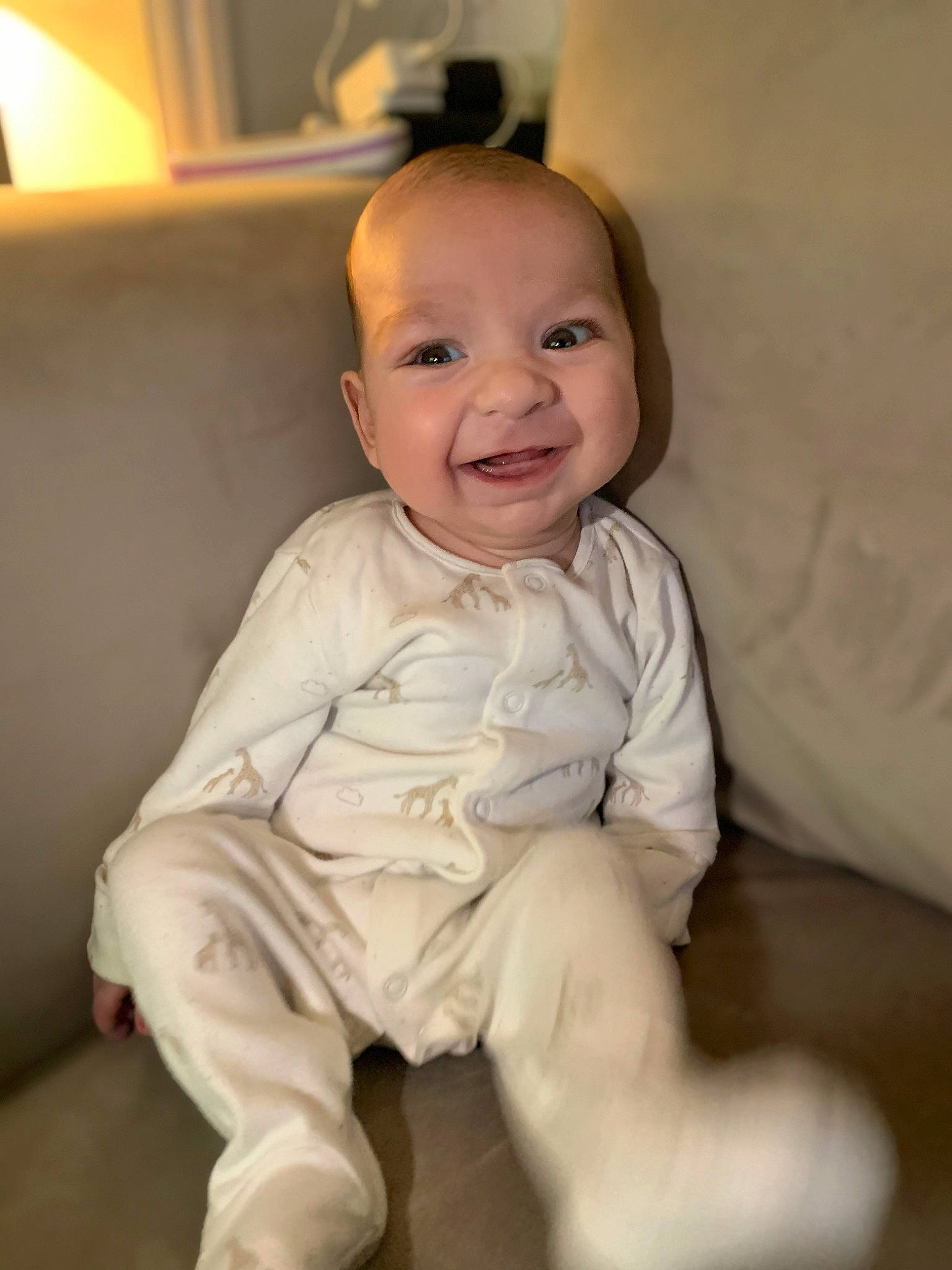 Kobi is registered to the contest to win money with this photo: baby, baby_toddler_clothing, cheek, comfort, eye, face, flash_photography, flooring, fun, happy, head, iris, joy, lamp, linens, person, picture_frame, room, sitting, sleeve