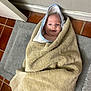 baby, towel, hood, floor, tile_floor, mat, indoor, child, wrapped, blanket, infant, cute, smile, face, head, skin, person, cozy, bath, young