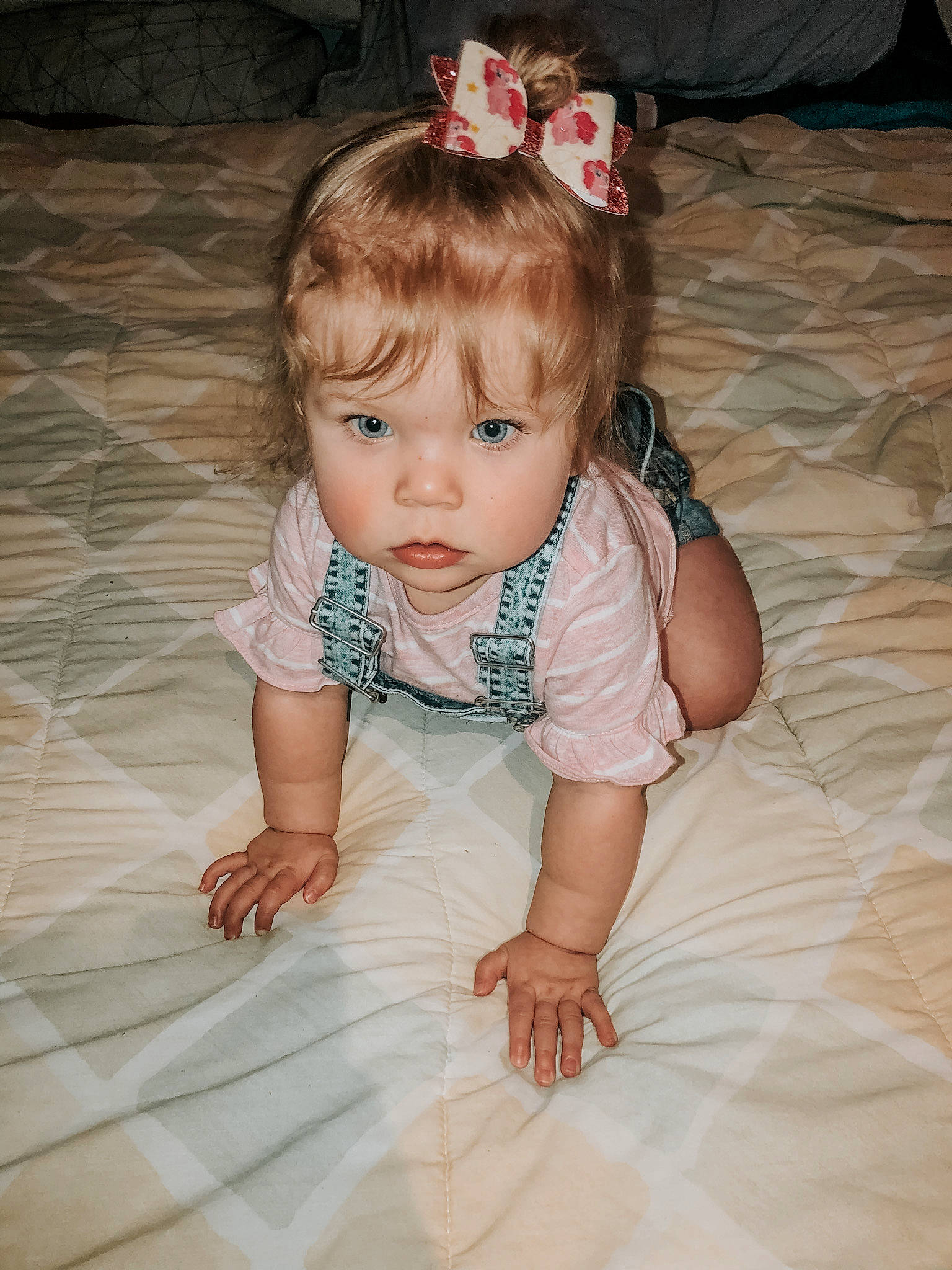 Lili is registered to the contest to win money with this photo: baby, cheek, child, dress, eye, face, fashion_accessory, floor, hair_accessory, head, headgear, iris, lip, person, photography, pink, product, sitting, skin, smile