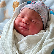 Elijah is registered to the contest to win money with this photo: baby, beanie, blanket, child, closeup, cozy, cute, face, headwear, indoors, infant, newborn, peaceful, portrait, resting, skin, sleeping, soft, swaddled, wrapped
