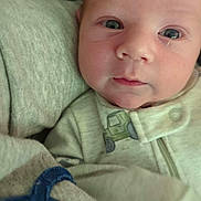Callaway is registered to the contest to win money with this photo: baby, infant, face, eyes, clothing, blanket, soft_texture, closeup, cute, newborn, child, portrait, sleepwear, cozy, expression, skin, head, young, indoors, resting