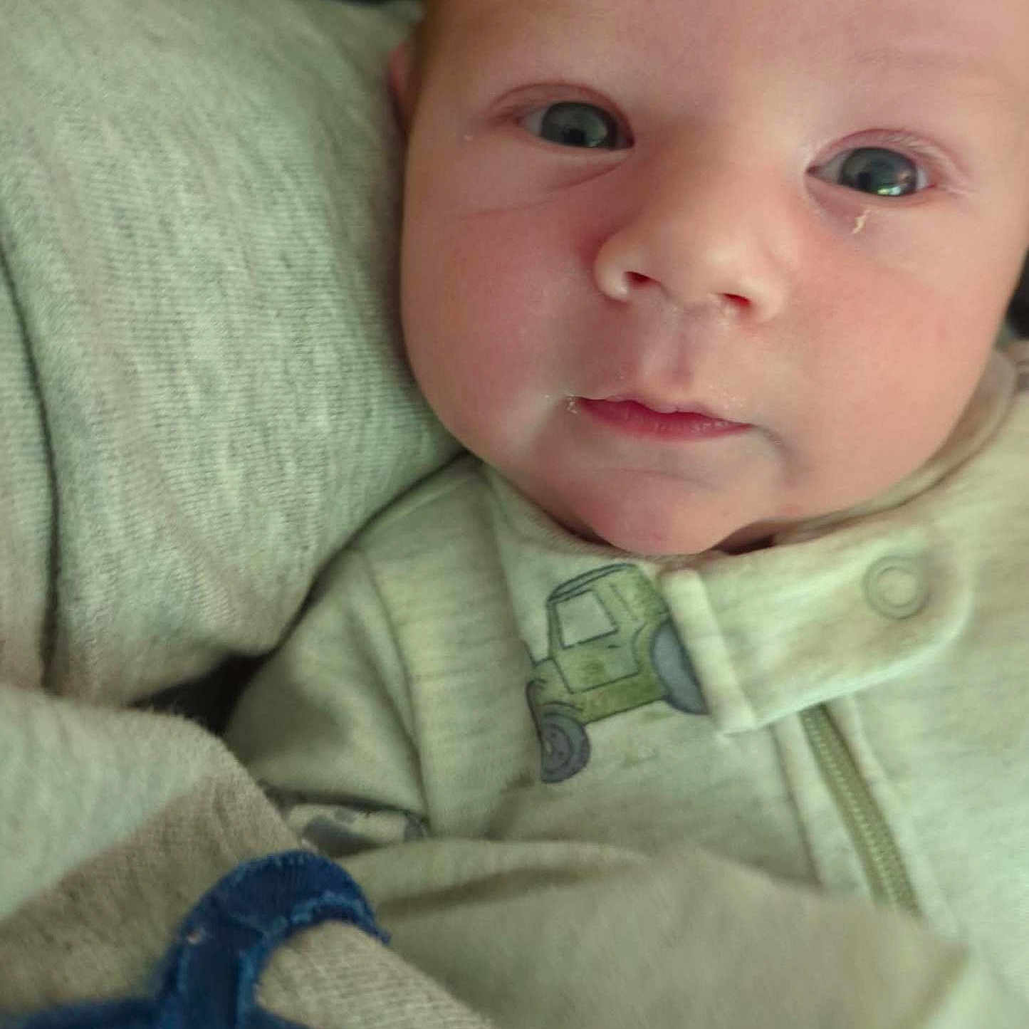 Callaway is registered to the contest to win money with this photo: baby, blanket, child, closeup, clothing, cozy, cute, expression, eyes, face, head, indoors, infant, newborn, portrait, resting, skin, sleepwear, soft_texture, young