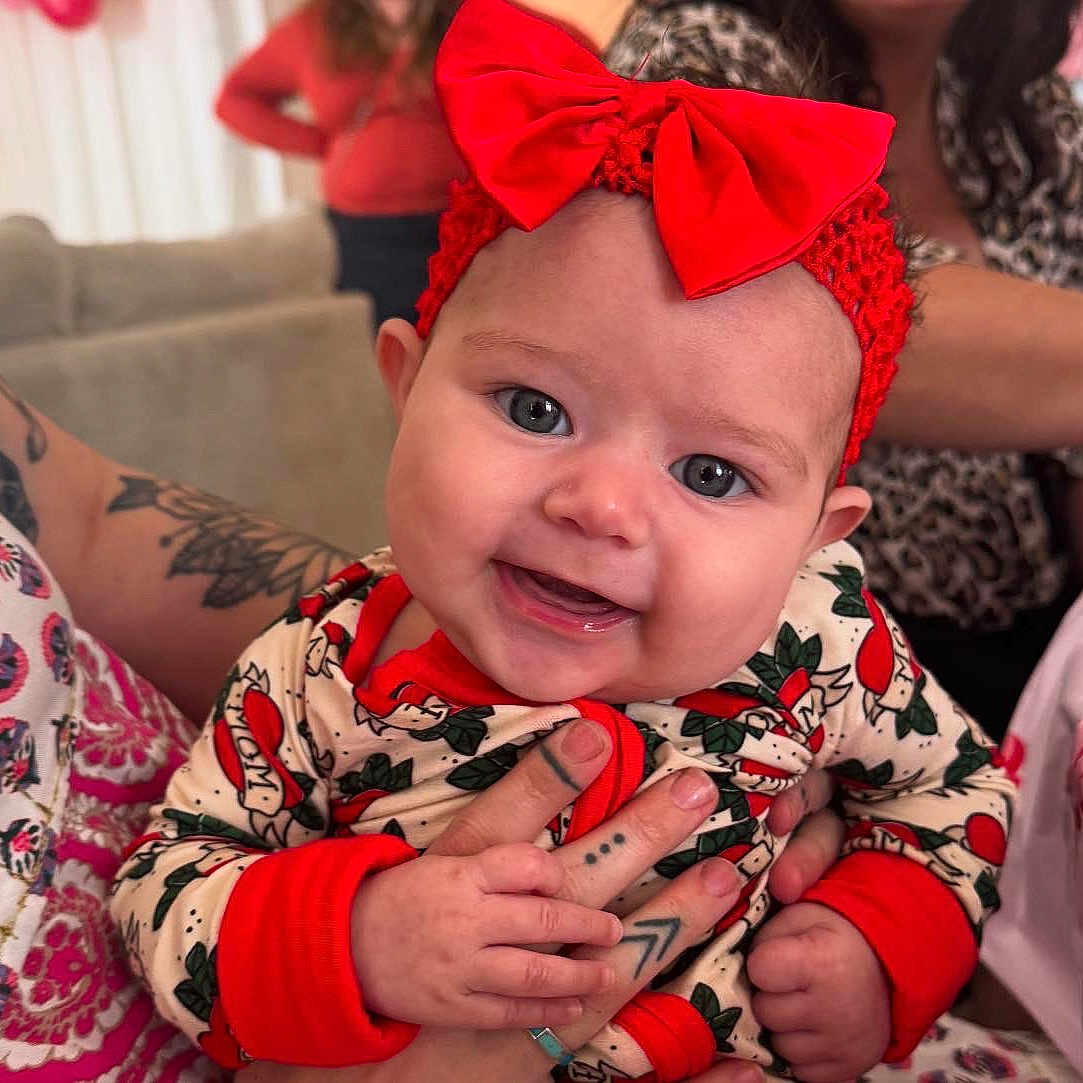 Suede joined the competition — help win amazing prizes! accessories, baby, babylaughing, bracelet, clothing, couch, dress, face, happy, head, jewelry, laughing, necklace, person, photography, portrait, scarf, skin, smile, tattoo