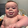baby, infant, child, high_chair, portrait, face, tongue, sticking_out_tongue, smiling, messy_face, food, milk, drool, blue_eyes, hair, chubby, sitting, indoor, bedroom, candid