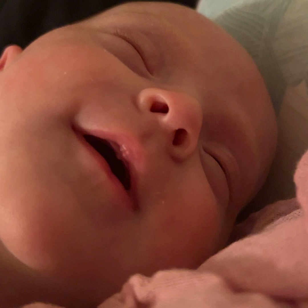 Ada is registered to the contest to win money with this photo: baby, bed, blanket, bodypart, cushion, face, furniture, head, homedecor, mouth, newborn, person, photography, portrait, sleeping