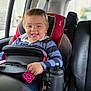 child, toddler, car_seat, smile, toy, water_bottle, car_interior, window, seatbelt, clothing, striped_shirt, seat, headrest, door, handle, happy, person, sitting, young_child, interior