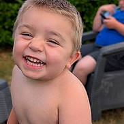 Manoé participe au concours pour gagner de l'argent avec cette photo : background, bare_chest, blur, candid, casual, chair, child, daylight, fun, grass, greenery, happy, outdoor, person, playing, short_hair, smiling, summer, toddler, toy