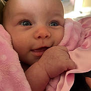 Harper-Mae is registered to the contest to win money with this photo: baby, infant, child, smiling, portrait, close_up, pink_blanket, cozy, indoor, face, eyes, blue_eyes, hand, cuddling, soft_fabric, warm_lighting, happy, sitting, home, candid