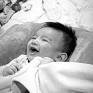 Amari Rey is registered to the contest to win money with this photo: baby, blanket, smile, cushion, toy, water_bottle, infant, happy, indoors, child, soft_texture, face, lying_down, monochrome, cozy, cute, hair, clothing, hand, portrait