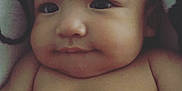 Amari Rey is registered to the contest to win money with this photo: baby, infant, face, skin, blanket, cheeks, cute, child, adorable, expression, portrait, lying_down, soft_texture, indoors, young, person, closeup, human, smile, head