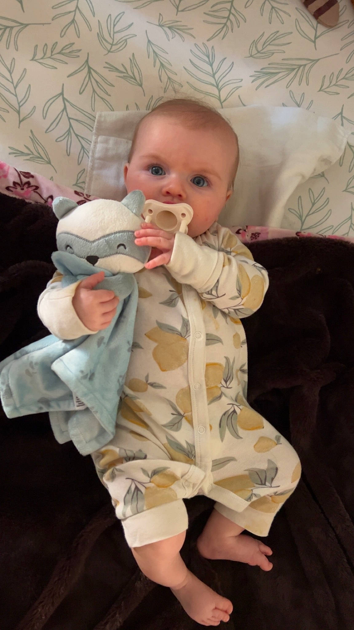 Lainey is registered to the contest to win money with this photo: baby, baby_products, baby_safety, baby_toddler_clothing, cheek, child, comfort, eye, fur, gesture, happy, head, linens, mammal, pattern, person, personal_protective_equipment, sitting, skin, sleeve