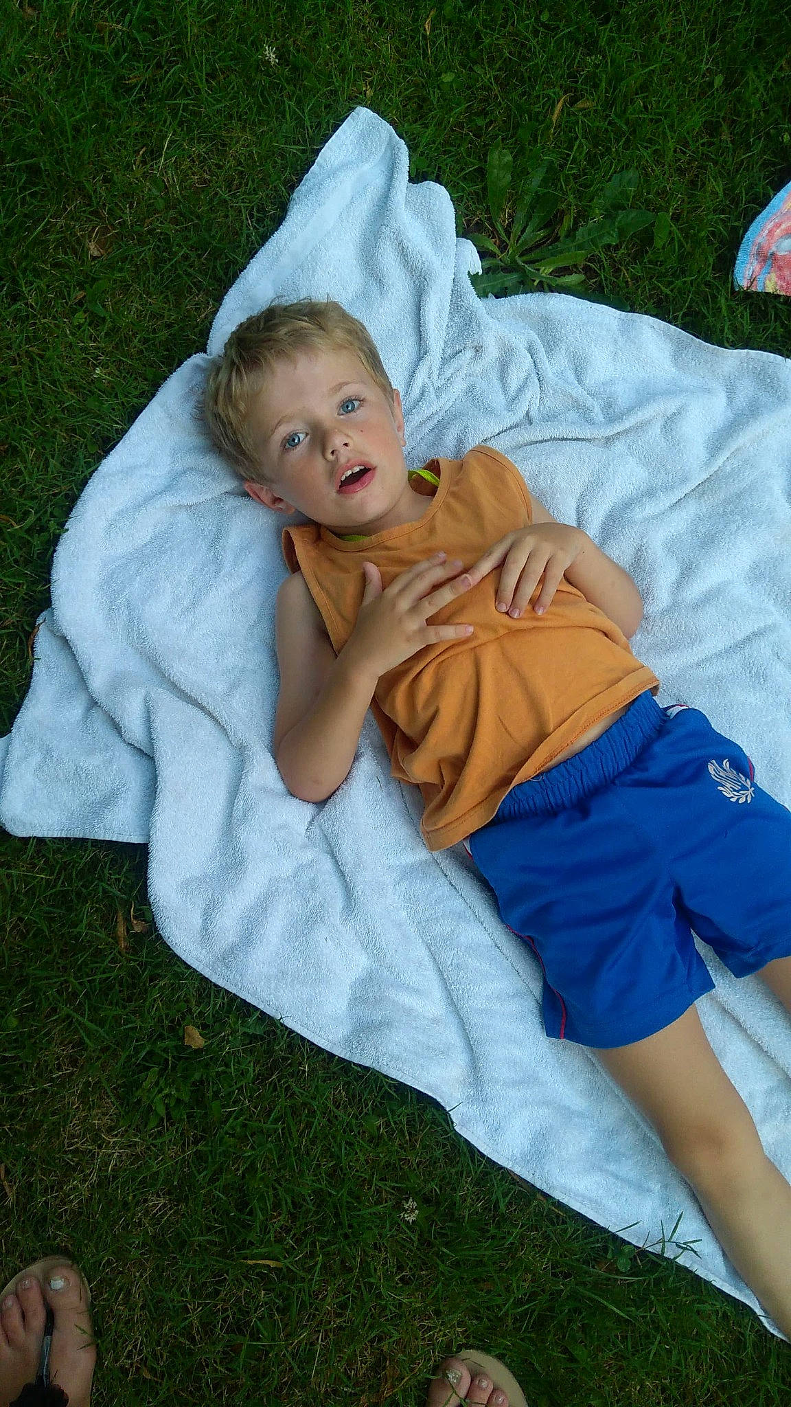 Léo participe au concours pour gagner de l'argent avec cette photo : baby_products, child, comfort, fun, grass, happy, human_leg, lap, lawn, leisure, linens, nap, people_in_nature, person, play, recreation, shorts, sitting, sleep, thigh