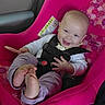baby, car_seat, child, smiling, happy, infant, seatbelt, pink, clothing, foot, hand, safety, vehicle_interior, cute, portrait, seat, person, young_child, toddler, bright_colors