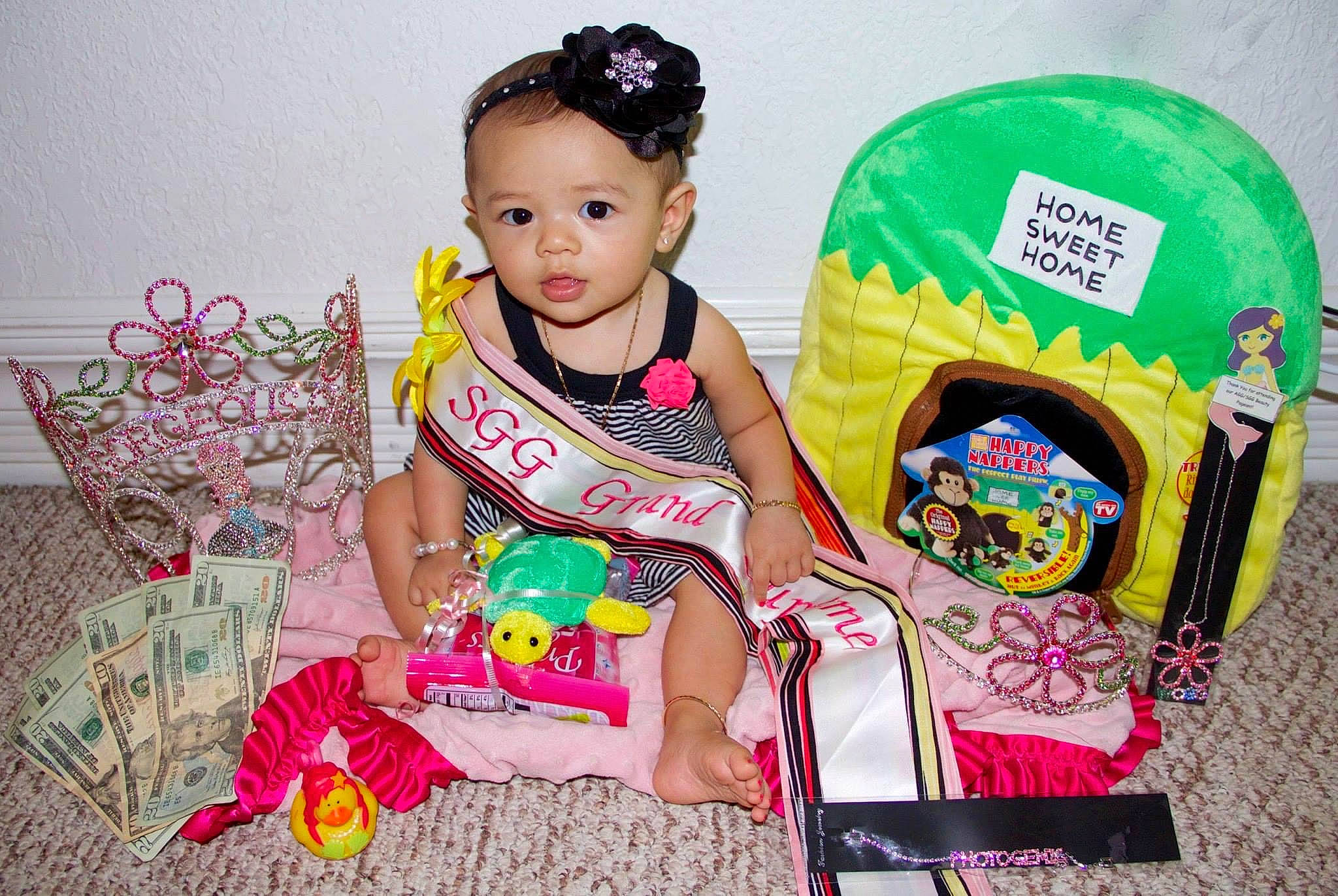 Isabella is registered to the contest to win money with this photo: baby, baby_playing_with_toys, baby_products, baby_toddler_clothing, baby_toys, child, event, fashion_accessory, fun, happy, magenta, pattern, person, pink, play, product, sitting, sleeve, smile, toddler