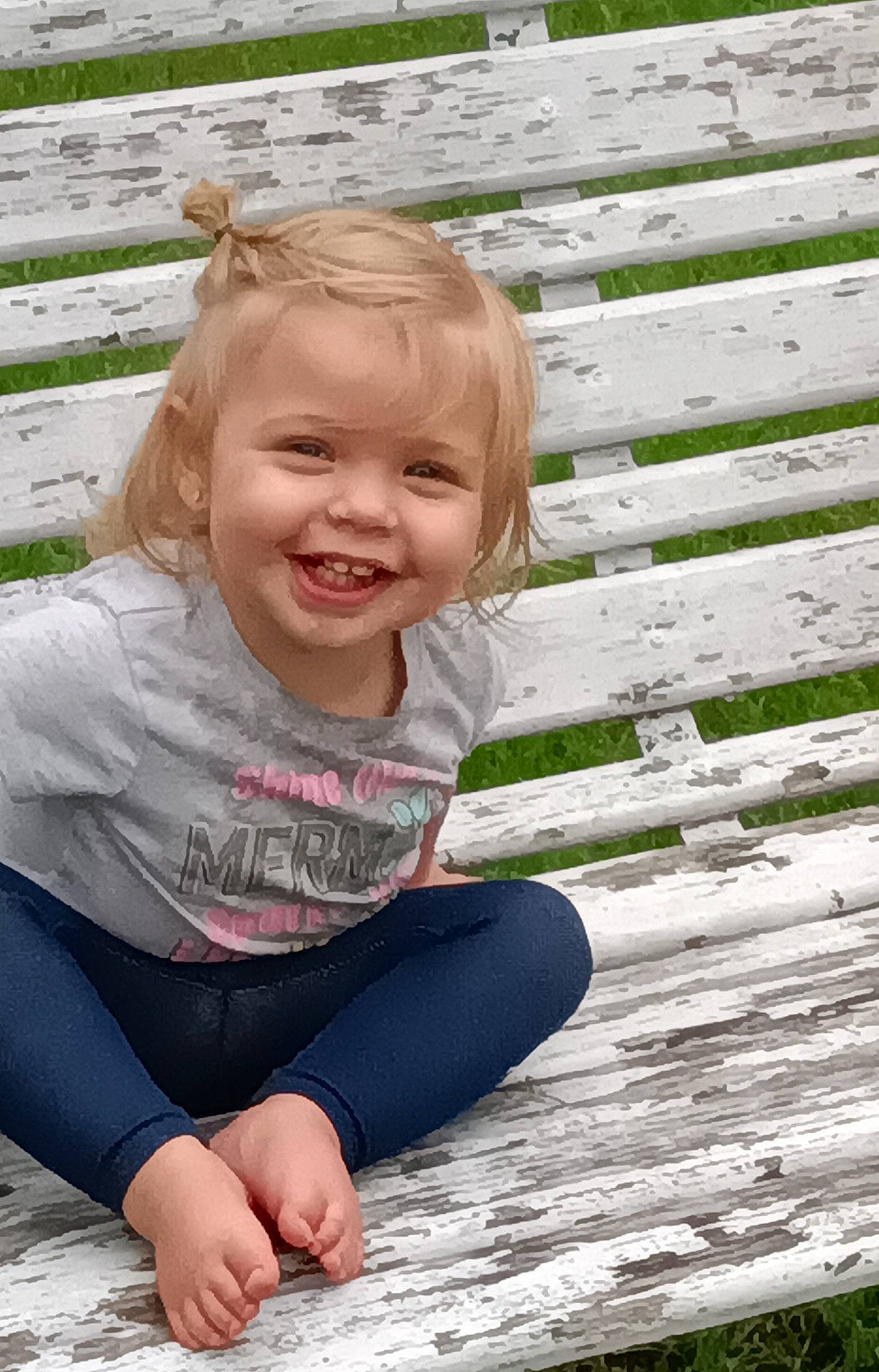 Bonnie is registered to the contest to win money with this photo: baby_toddler_clothing, barefoot, blond, child, denim, fun, grass, hair, happy, head, joy, leisure, people_in_nature, person, plant, sitting, skin, smile, t_shirt, toddler