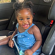 Alexis is registered to the contest to win money with this photo: toddler, child, smiling, car_seat, pacifier, blue_dress, afro_hairstyle, hair_puffs, seatbelt, car_interior, happy, cute, young_child, sitting, indoors, person, portrait, baby, joyful, seat