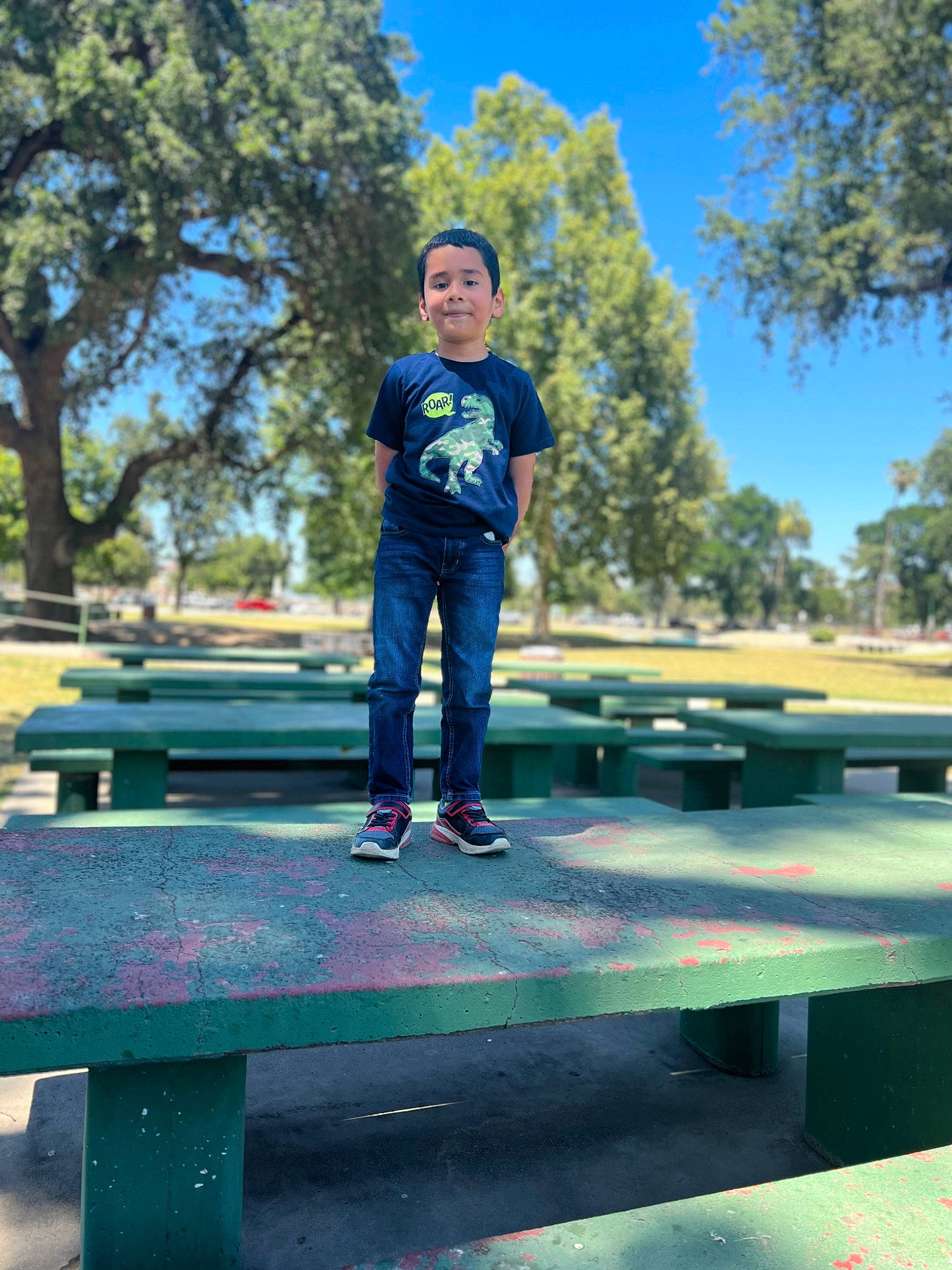 Jayden joined the competition — help win amazing prizes! asphalt, boot, child, denim, fun, grass, happy, landscape, leisure, morning, person, plant, recreation, road, rolling, sitting, sky, t_shirt, tree, wood